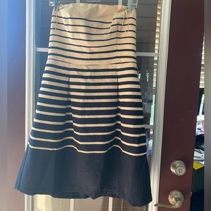 Cream and black striped strapless dress.